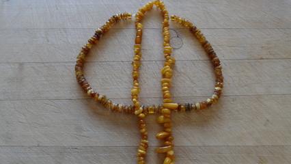 amber beads on a wooden background