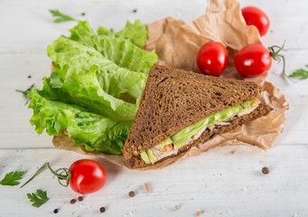 Club sandwich with chiken and cucumbers on dark rye bread