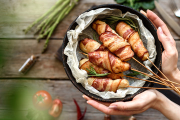 Roll with bacon and chicken mince on a stew with fresh asparagus