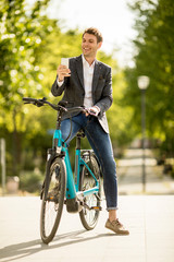 Young businessman on the ebike make selfie photograph with mobile phone