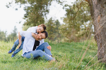 Naklejka na ściany i meble Stilish mother and handsome son having fun on the nature. Happy family concept. Beauty nature scene with family outdoor lifestyle. Happy family resting together. Happiness and harmony in family life.