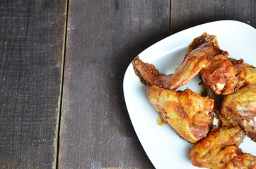 plate of chicken wings on brown wooden table