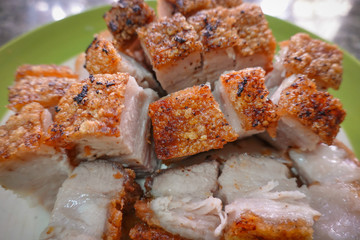 traditional Thai culture air fryer fried pork cuisine style or moo tod krob favorite famous street fast foods menu at thailand homemade
with hot spicy sauces on table wood dish sticky rice vegetable