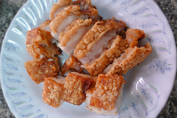 traditional Thai culture air fryer fried pork cuisine style or moo tod krob favorite famous street fast foods menu at thailand homemade
with hot spicy sauces on table wood dish sticky rice vegetable