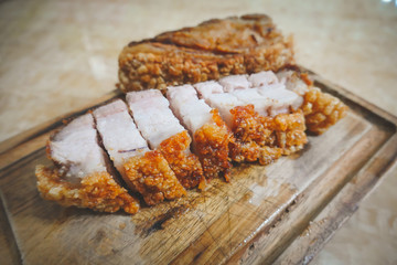 traditional Thai culture air fryer fried pork cuisine style or moo tod krob favorite famous street fast foods menu at thailand homemade
with hot spicy sauces on table wood dish sticky rice vegetable