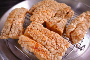 traditional Thai culture air fryer fried pork cuisine style or moo tod krob favorite famous street fast foods menu at thailand homemade
with hot spicy sauces on table wood dish sticky rice vegetable