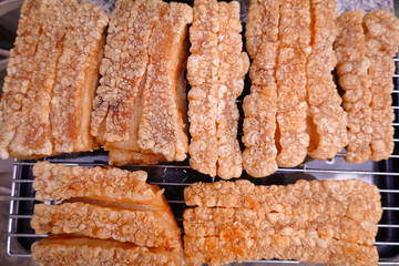 traditional Thai culture air fryer fried pork cuisine style or moo tod krob favorite famous street fast foods menu at thailand homemade
with hot spicy sauces on table wood dish sticky rice vegetable