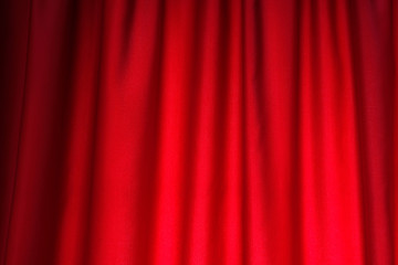 Bright red curtain decoration close up. Smooth folds of fabric.