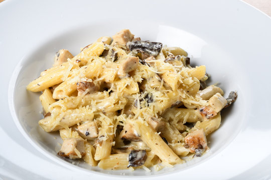 Traditional authentic italian penne al pollo e funghi pasta with mushroom ,chicken, parmesan cheese.