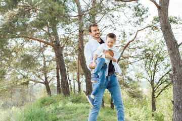 Happy time with father. Family fun concept. Bearded man and cute son Kids smile. Spring time walk with father.