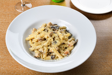 Traditional authentic italian penne al pollo e funghi pasta with mushroom ,chicken, parmesan cheese.