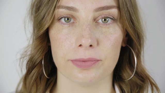 Close up portrait of attractive woman with green eyes. female look at camera