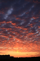 Bright gradient sunset with clouds on the horizon