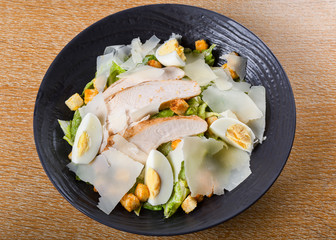 A Caesar salad is a green salad of romaine lettuce and croutons dressed with lemon juice, egg
