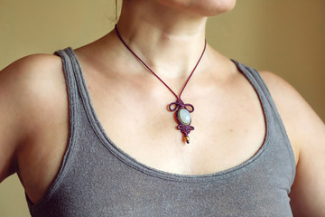 Female neckline wearing elegant necklace with natural mineral gemstone
