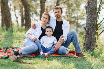 Fototapeta premium happy young couple with their children have fun at beautiful park outdoor in nature