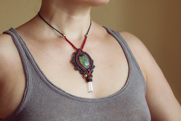 Female neckline wearing elegant necklace with natural mineral gemstone