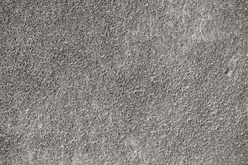 interesting, unusual texture of a wall with a dusting of gray dark concrete