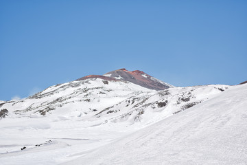 Fototapeta na wymiar Snowy volcano with smoke in sicily
