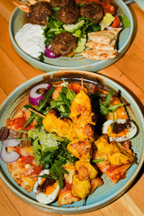 Chicken tandoori with rucola salad, egg with sumac spice, pitta bread. Asian dish