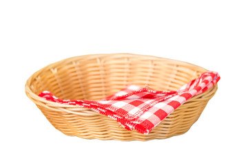 Obraz premium Wicker basket with red cotton napkin inside isolated on a white background