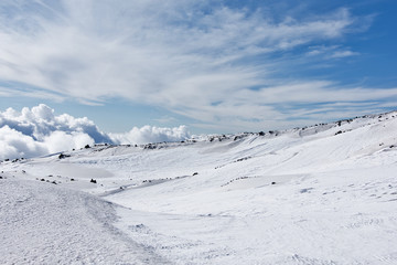 Fototapeta na wymiar Snowy side of a volcano mountain in Sicily