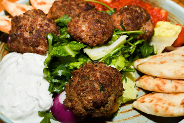 Mediterranean meatballs with salad, chickpeas with tomato sauce, yogurt dip and pita bread