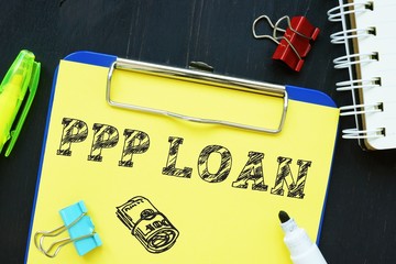 Business concept about PPP Loan with sign on the page.