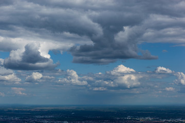 Aerial view from mountain Medvednica on Zagreb city, small in the distance, with beautiful white clouds high in the sky