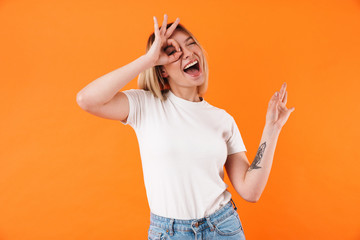 Image of joyful caucasian woman smiling and gesturing ok sign