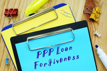 Conceptual photo about PPP Loan Forgiveness  with handwritten text.