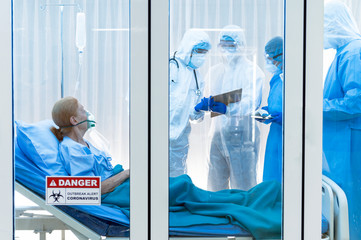Infested coronavirus covid 19 patient in clean quarantine room with danger outbreak alert sign with team of coronavirus covid 19 experts discussion