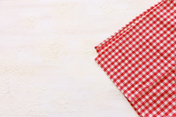 top view of checkered tablecloth with over white wooden background