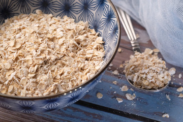 Close up of oats flakes in a bowl on table 