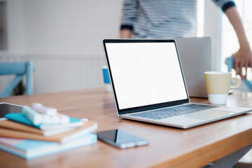 Mockup blank white desktop screen tablet with a man working in background. White screen tablet for graphic montage.