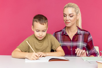 Tutor with child doing homework together at home