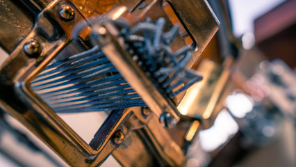 Close up shot of snare drum throw off mechanism and snare wires from the 1930s. Engraved guilt gold hoops