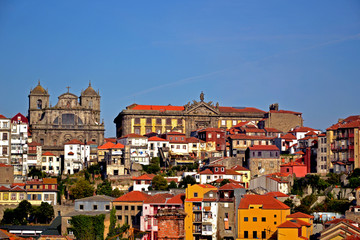 Fototapeta premium Porto, Portugal - August 17, 2015: Cityscape of Porto. Focus on a church and a big building beside.