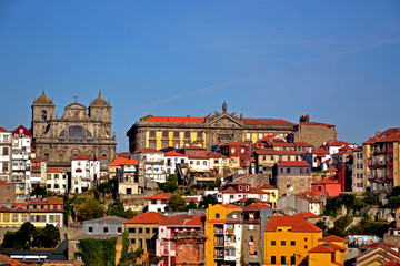 Porto, Portugal - August 17, 2015: Cityscape of Porto. Focus on a church and a big building beside.