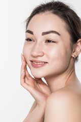 Beautiful face of a young woman with clean fresh skin isolated on white background. Skincare and body care concept.