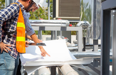Engineers are checking the air cooled chiller, located on the roofs of the building.