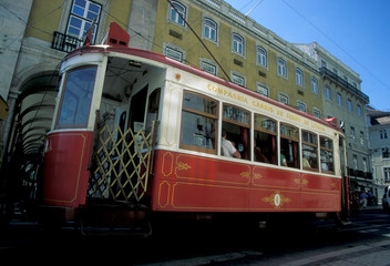 Plakat People Traveling In Cable Car Against Building On City Street