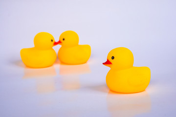 Yellow duck toys isolated on white background for friendship and unity concept.