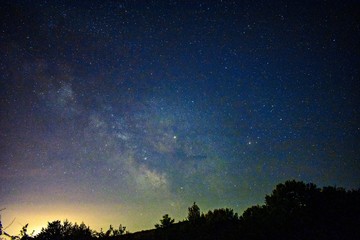 Obraz na płótnie Canvas night sky with milky way galaxy shining trough stars and planets
