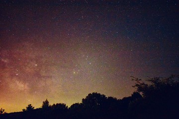 Fototapeta na wymiar night sky with milky way galaxy shining trough stars and planets
