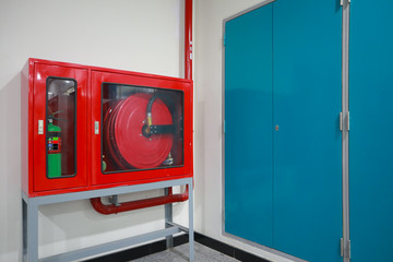 Fire extinguisher and fire hose reel on the wall.