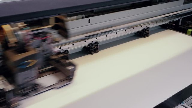 Moving print head of a large printing press.