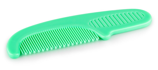 green comb on a white background