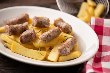 Fried potatoes with italian traditional salsiccia, selective focus