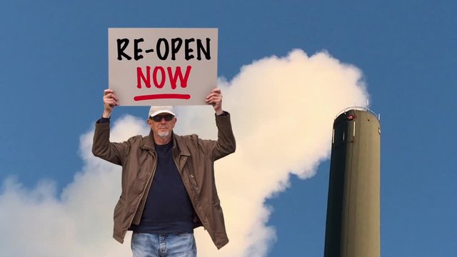 American worker with cap standing in front of industrial smoking chimney
with board sign saying Re-open Now. Corona Covid-19 lockdown protest. Collage image with copy space.